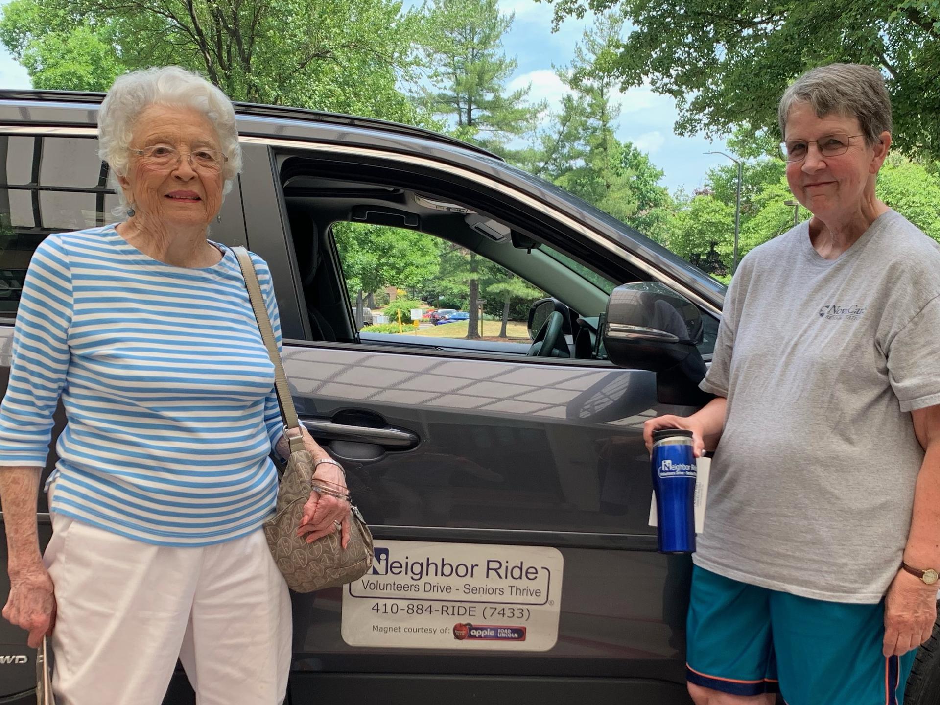 Neighbor Ride volunteer driver and her passenger standing outside of a car